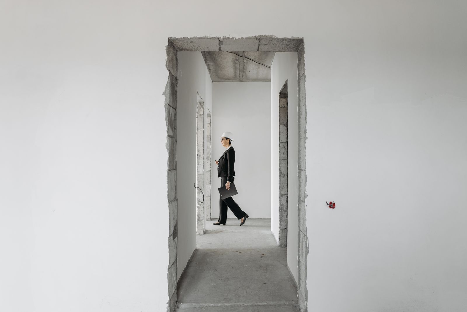 Property professional inspecting an unfinished building