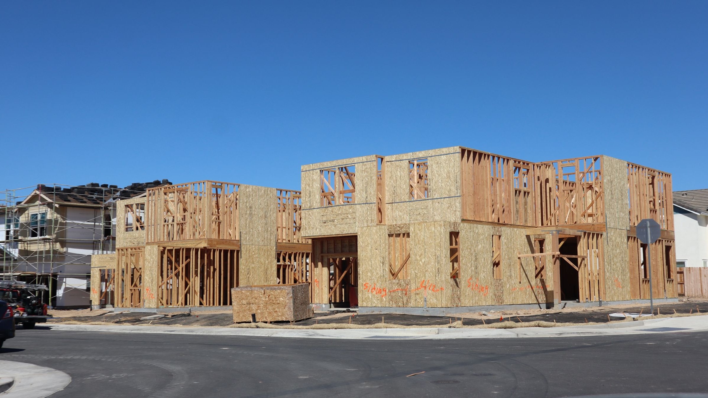 New houses at timber frame stage on a suburban street