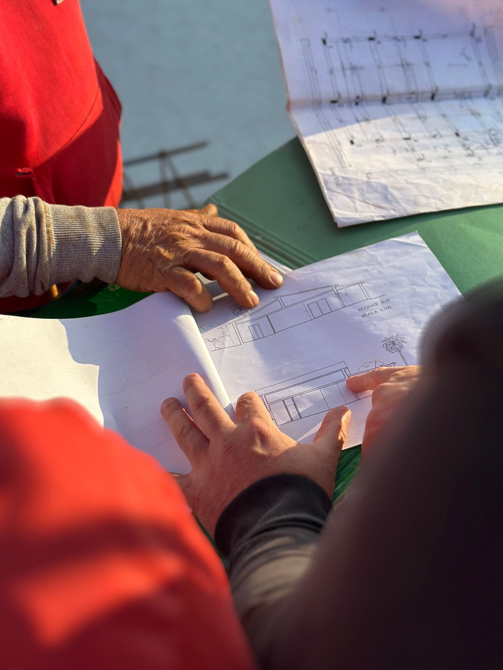 Construction specialists reviewing plans together on site