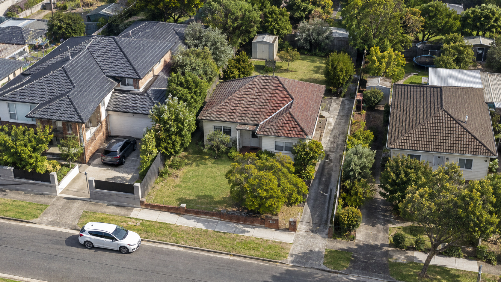 AI-generated illustration of a suburban block with side access and rear yard