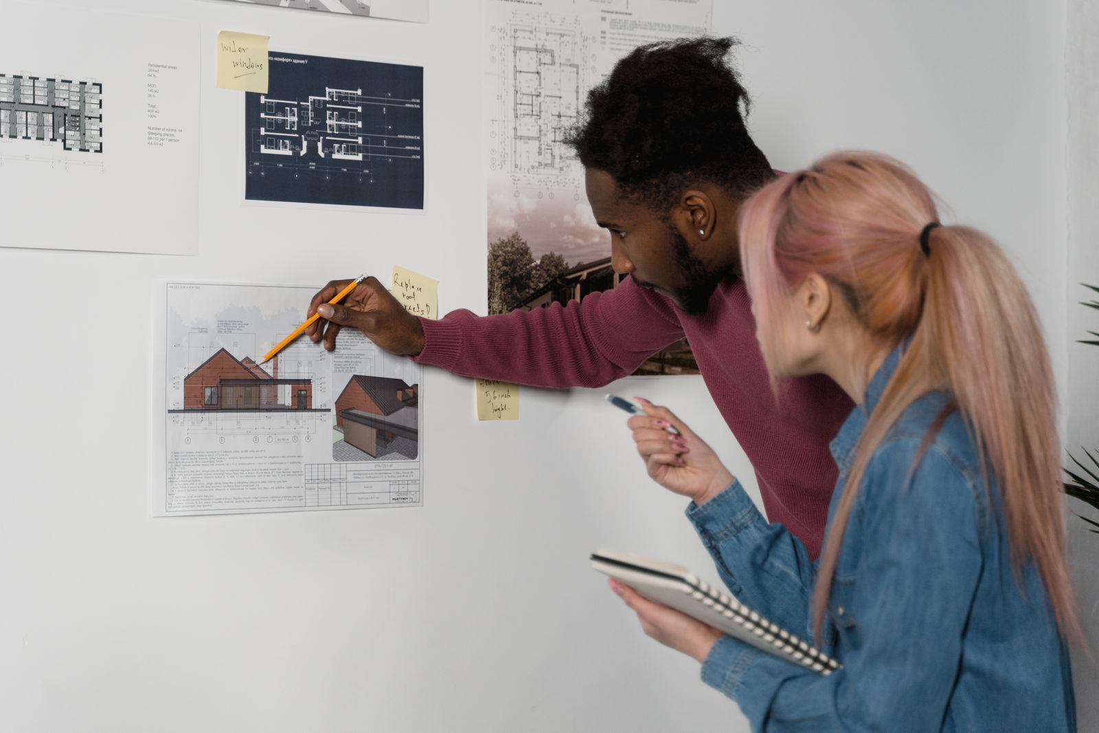 Design team comparing housing plans and eligibility requirements