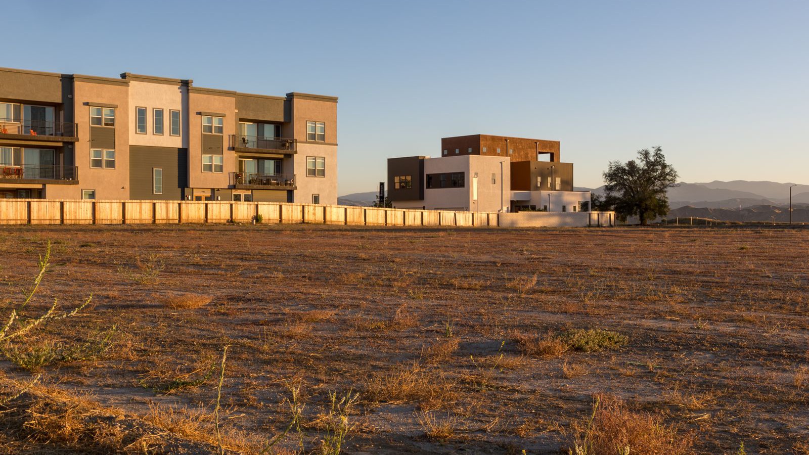 Undeveloped land parcel for development in front of new townhouses