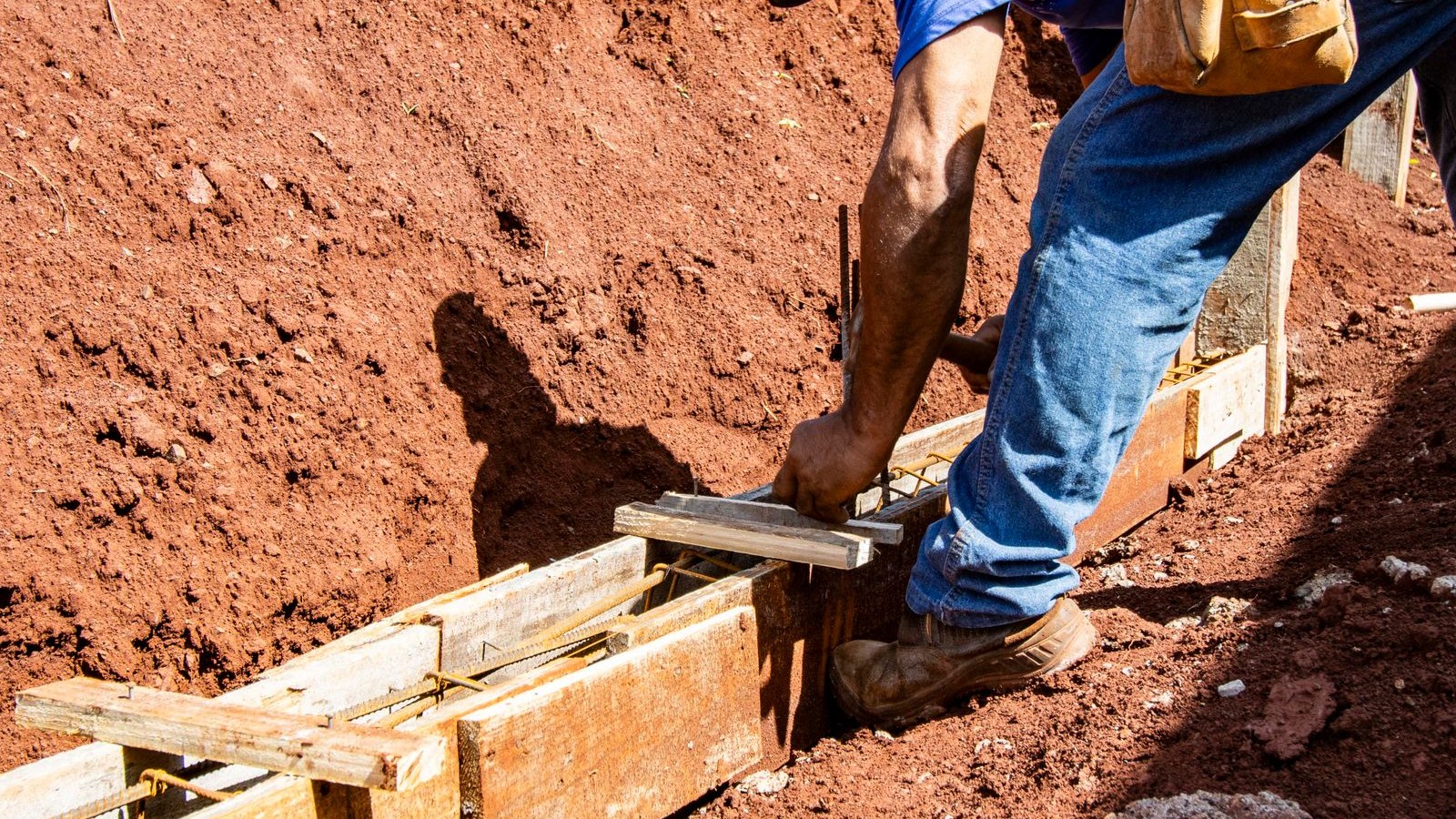 Worker setting formwork and reinforcement for a footing