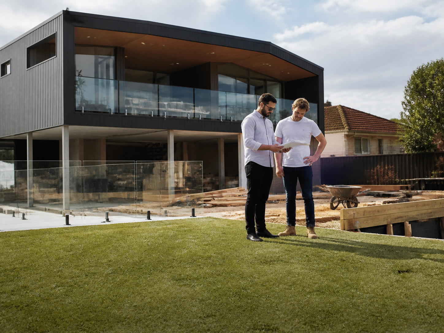 Australian property investor reviewing a contract with a seller across a kitchen table
