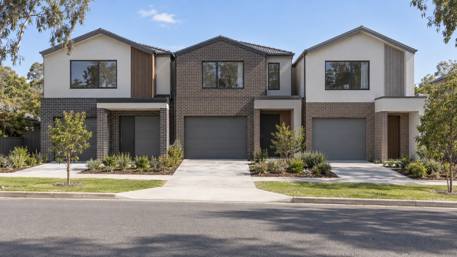 Three attached two-storey infill townhouses seen from across the road